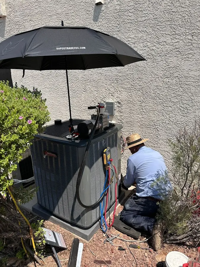 HVAC technician performing outdoor AC maintenance in Inkster